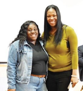 ShatoriaRackins presented the $500 A Child's World Daycare & Academy Scholarship to Zyanisha Harris.